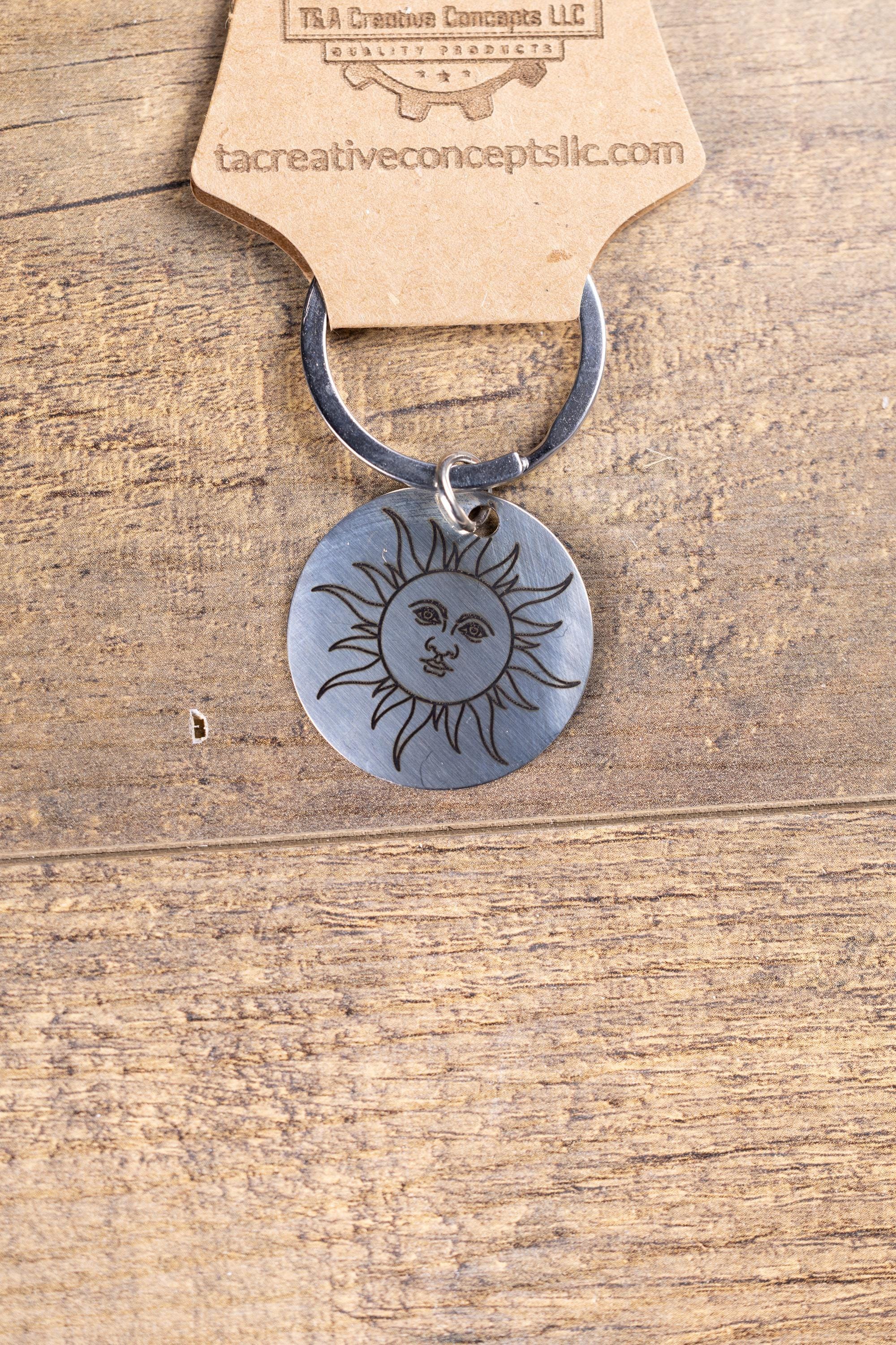 Polished stainless steel sun keychain | laser engraved celestial design | same image both sides | durable gift
