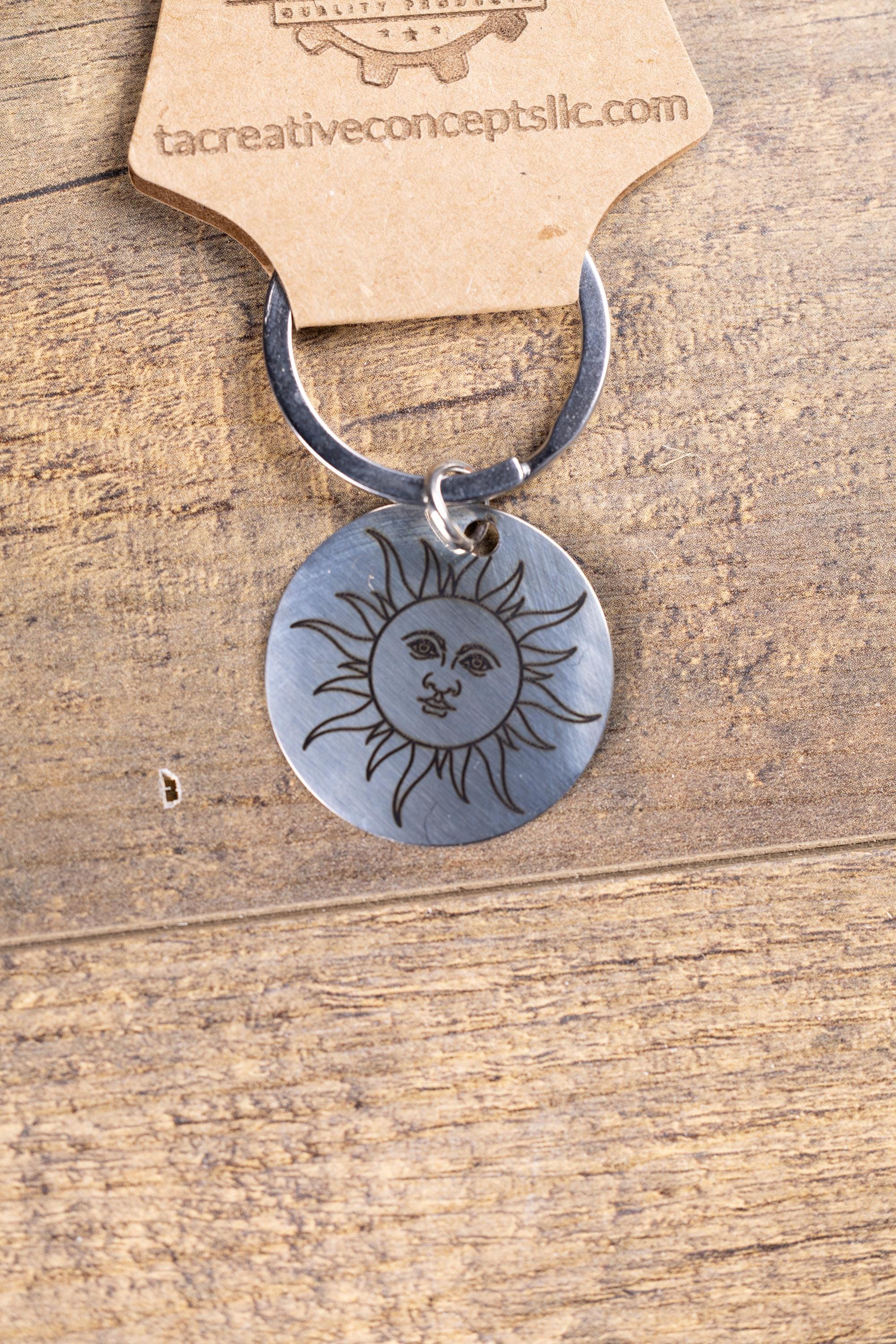 Polished stainless steel sun keychain | laser engraved celestial design | same image both sides | durable gift