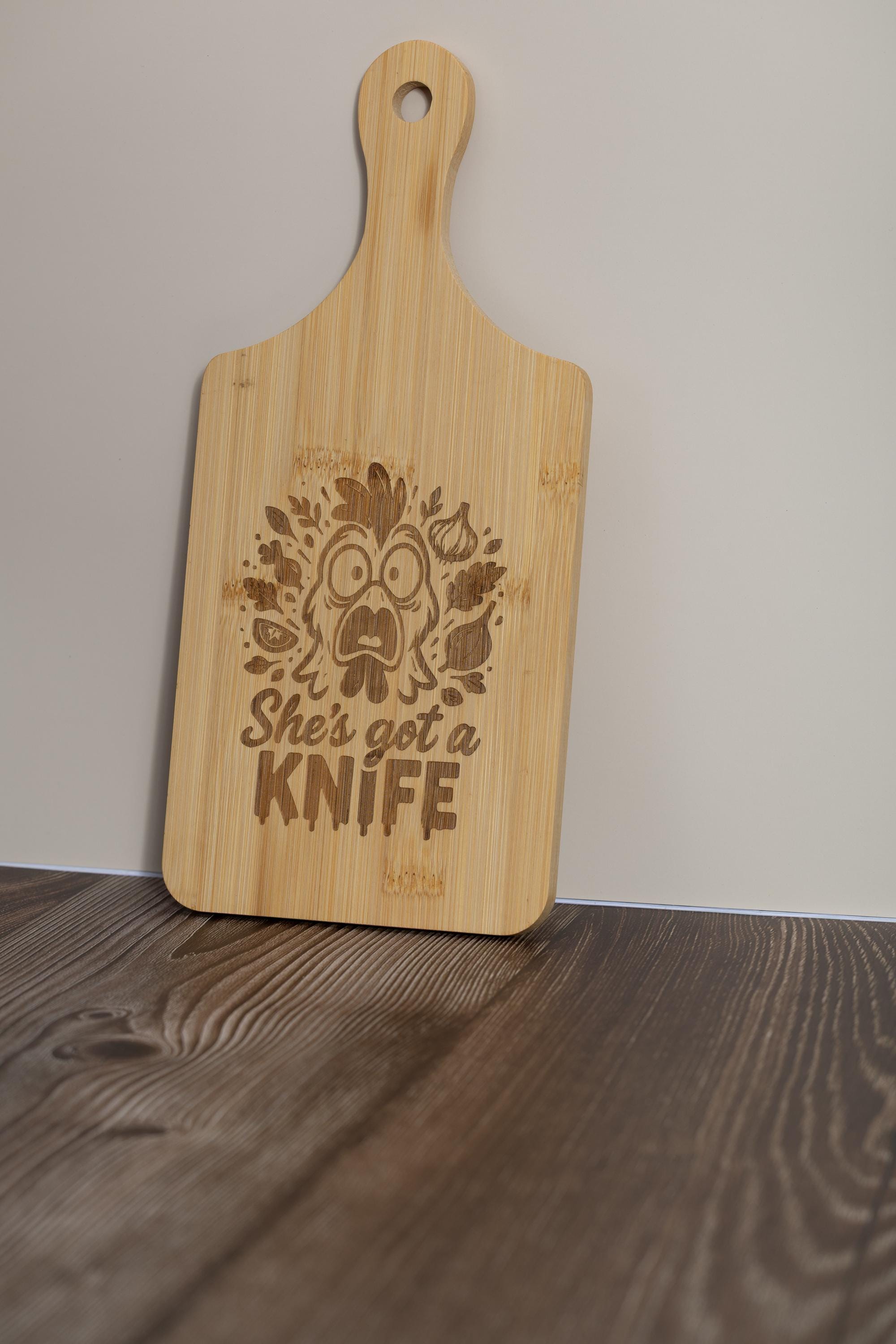 Funny laser engraved bamboo cutting board - "she's got a knife" kitchen decor (5"x11")