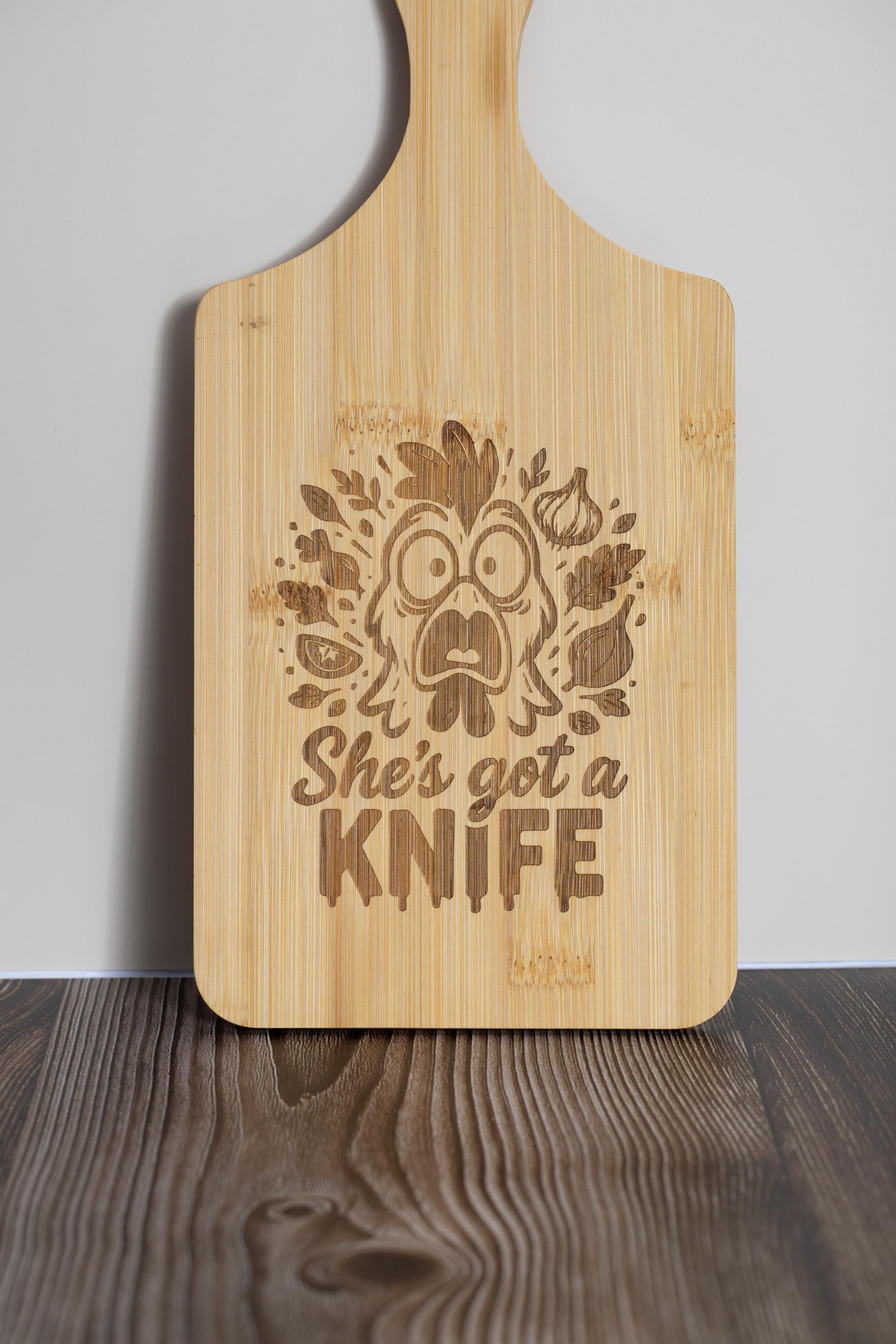 Funny laser engraved bamboo cutting board - "she's got a knife" kitchen decor (5"x11")