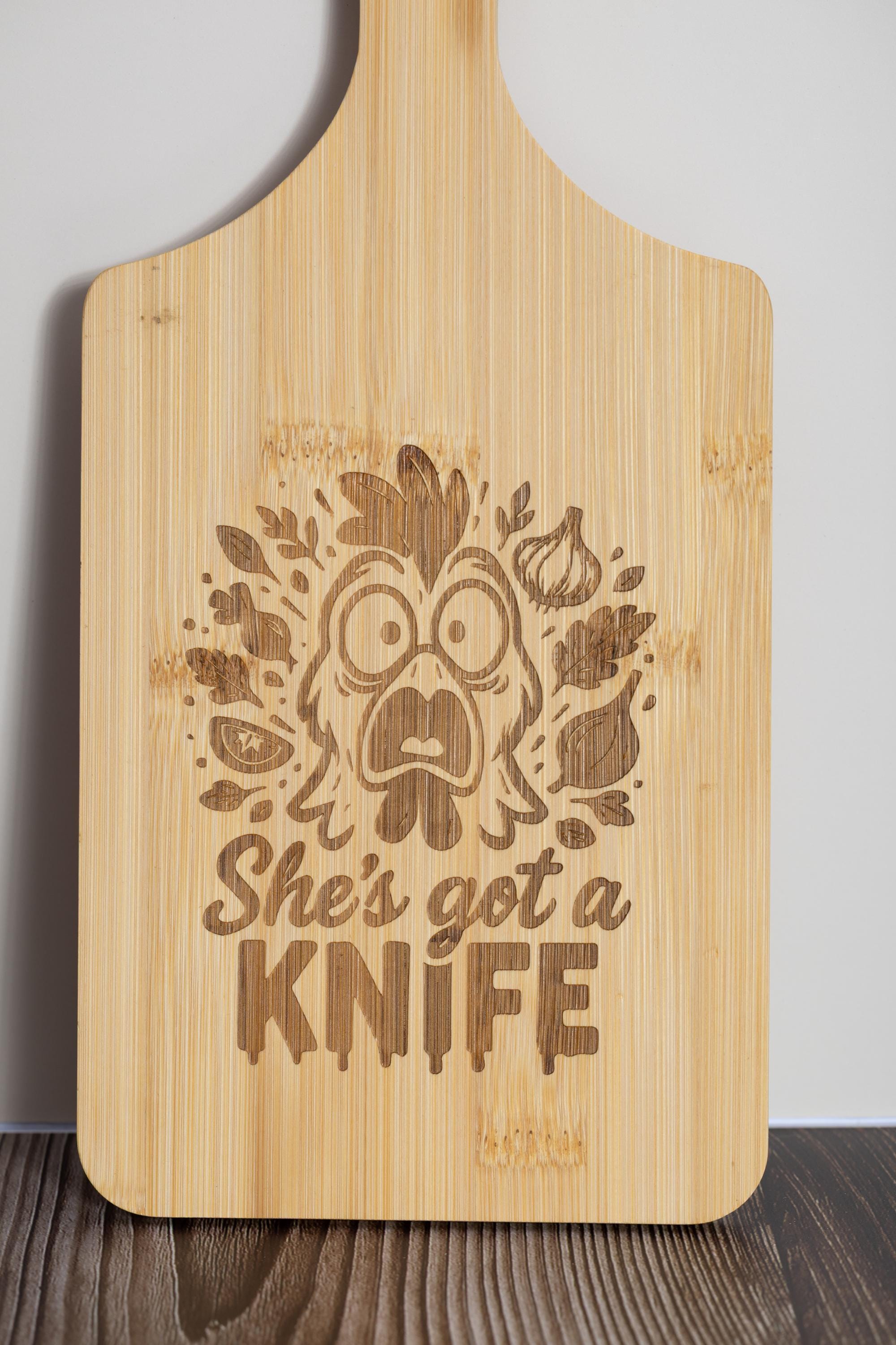 Funny laser engraved bamboo cutting board - "she's got a knife" kitchen decor (5"x11")