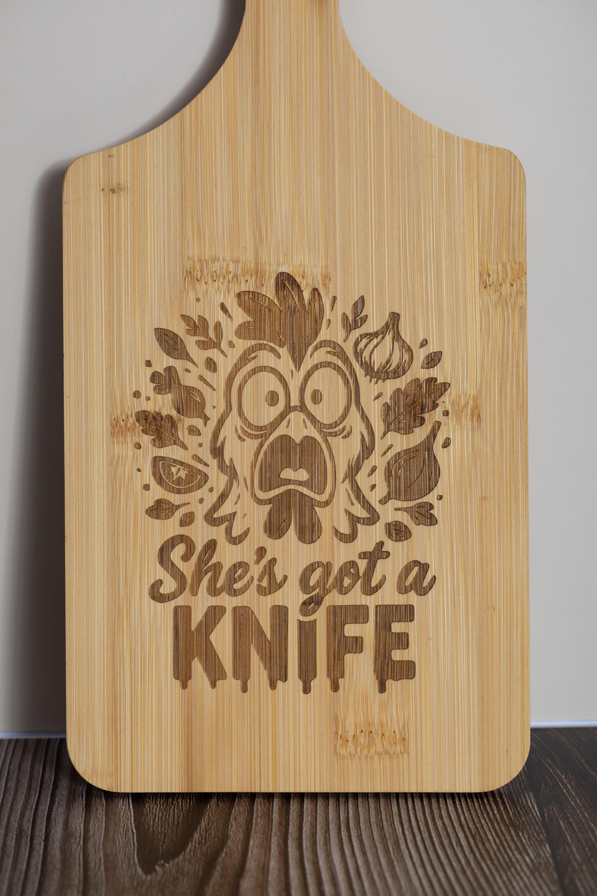 Funny laser engraved bamboo cutting board - "she's got a knife" kitchen decor (5"x11")