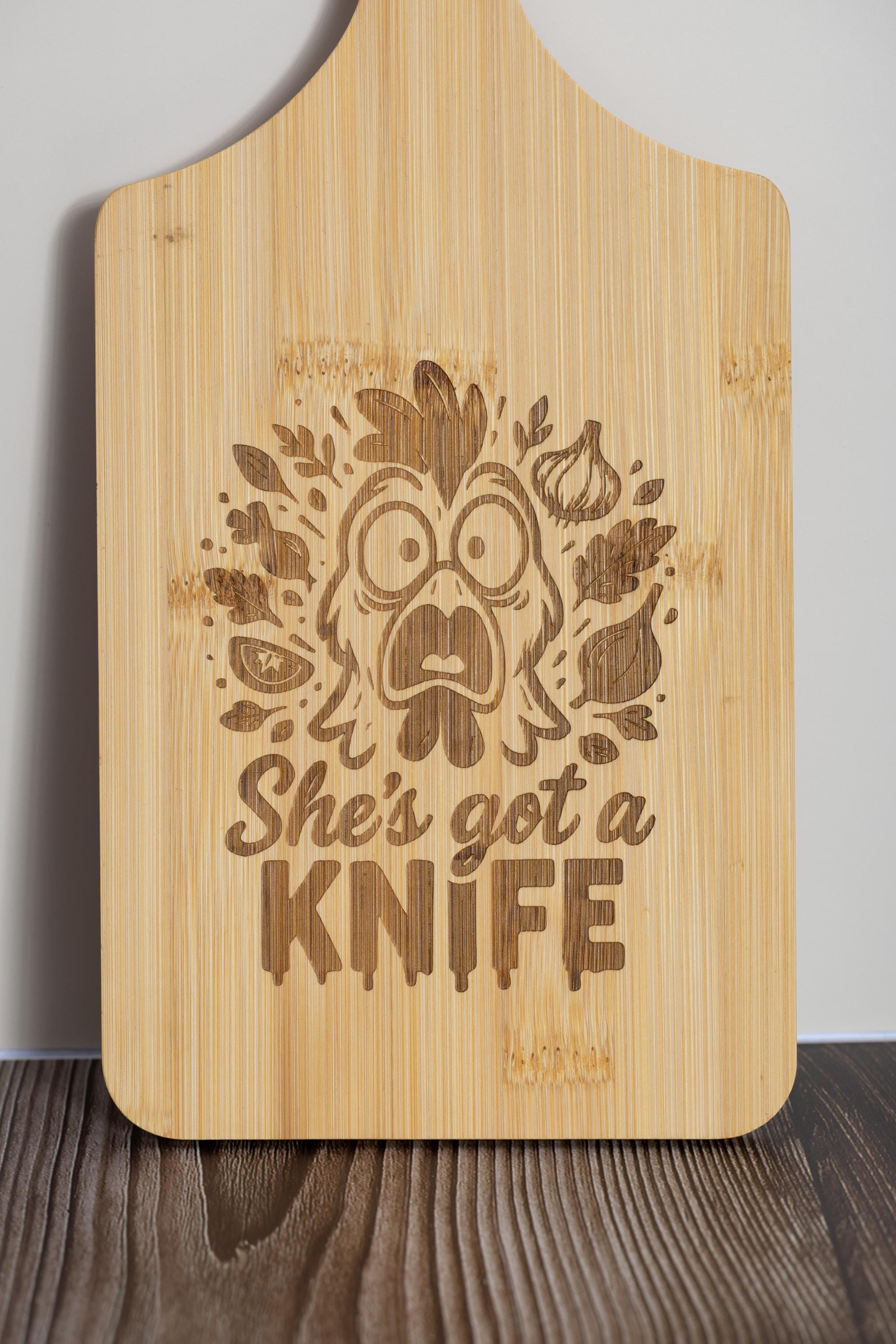 Funny laser engraved bamboo cutting board - "she's got a knife" kitchen decor (5"x11")