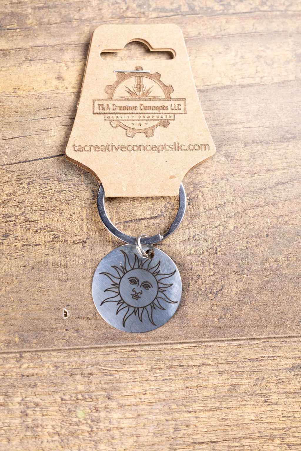 Polished stainless steel sun keychain | laser engraved celestial design | same image both sides | durable gift