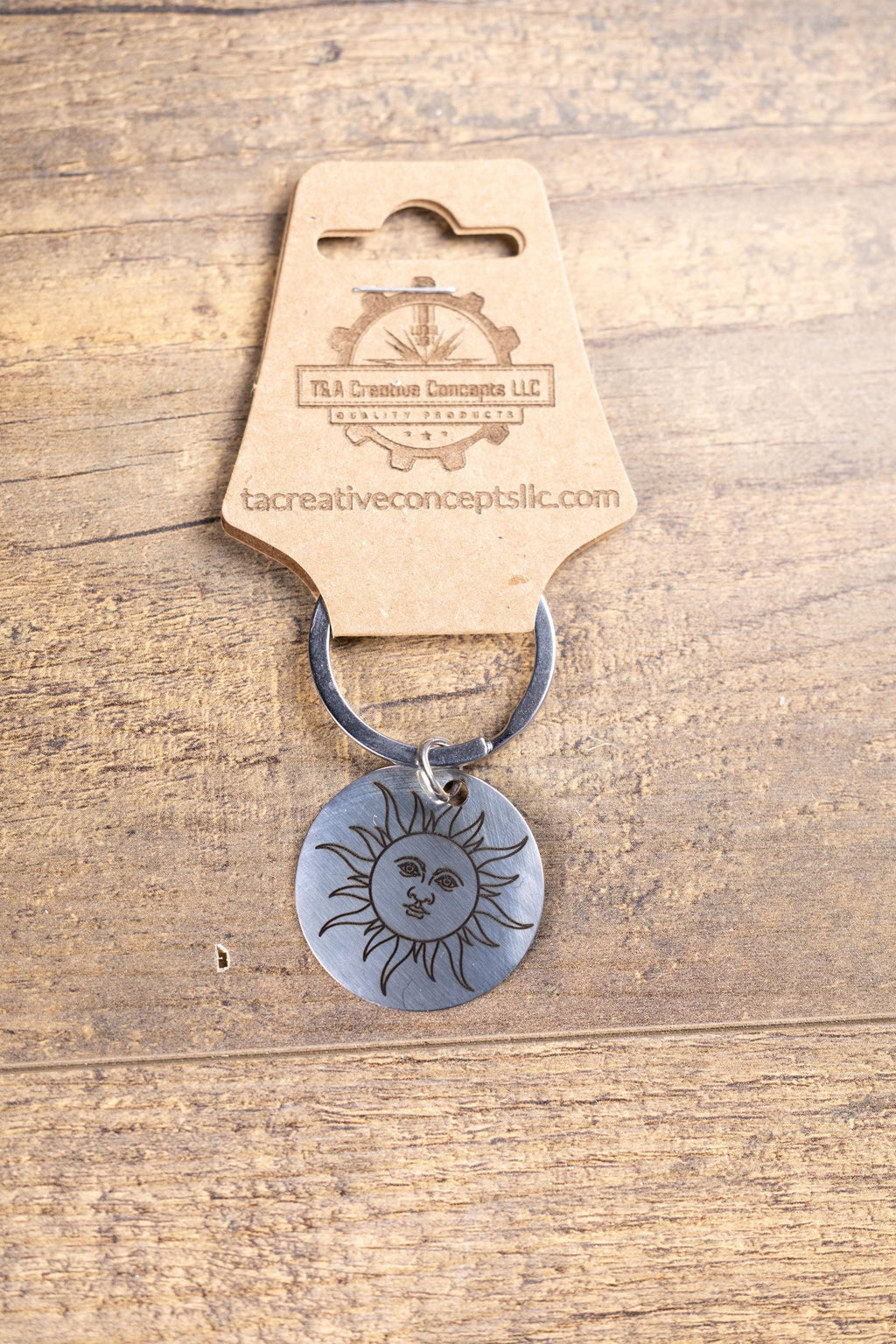 Polished stainless steel sun keychain | laser engraved celestial design | same image both sides | durable gift