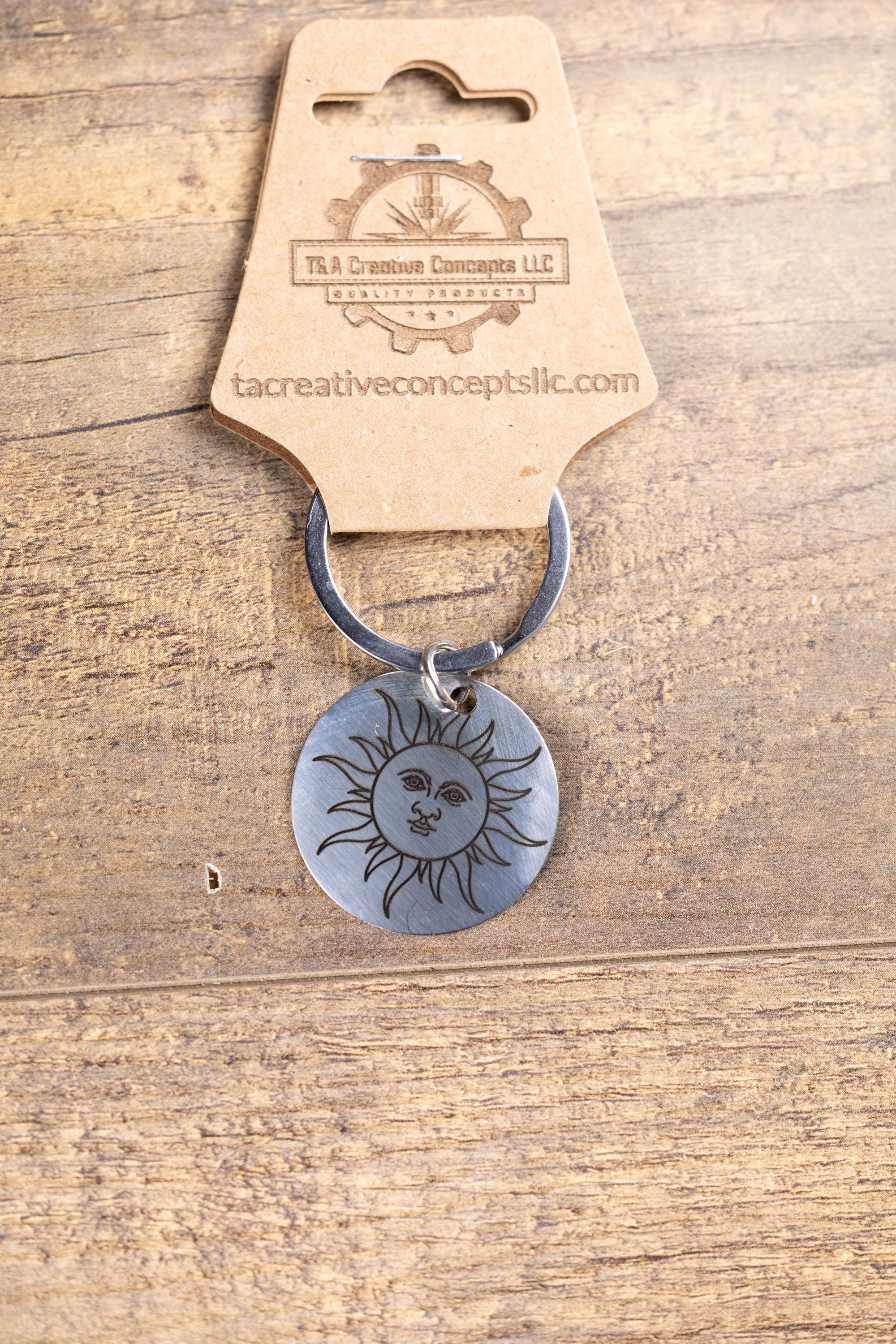 Polished stainless steel sun keychain | laser engraved celestial design | same image both sides | durable gift